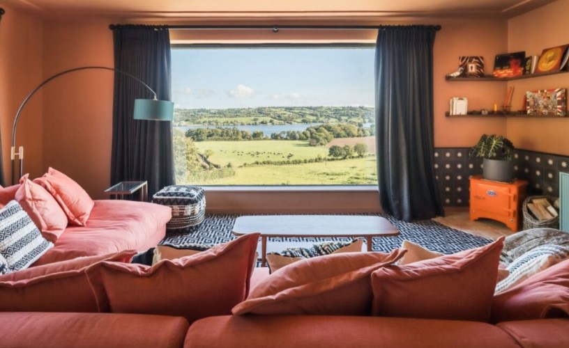Pink lounge area in house overlooking countryside